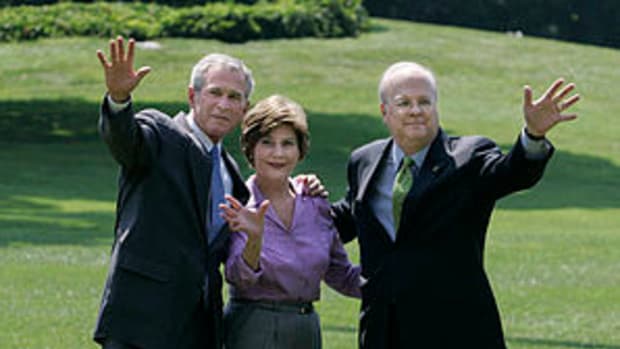 President George W. Bush stands with Mrs. Laur...