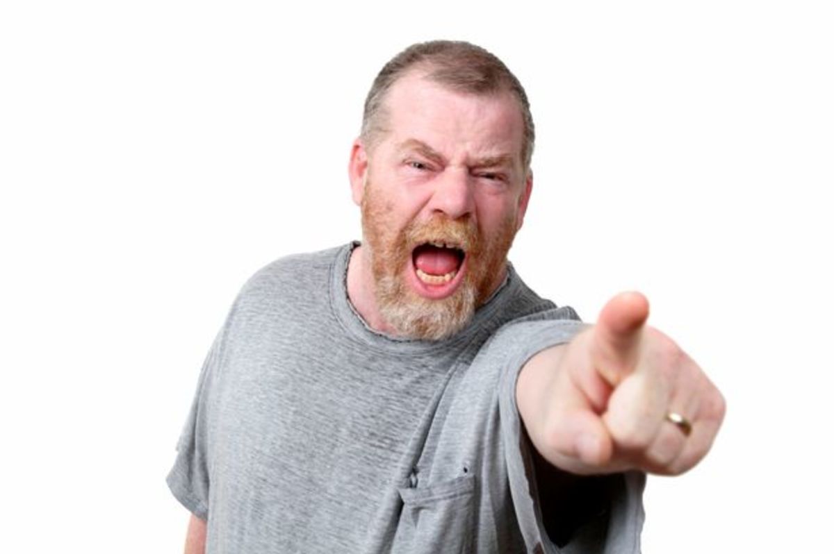 Angry-man-shouting-and-pointing-to-camera-studio-shot
